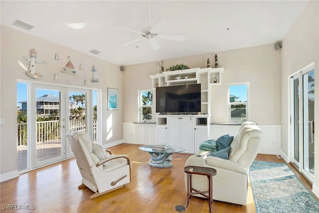 living room featuring ceiling fan and light hardwood / wood-style floors