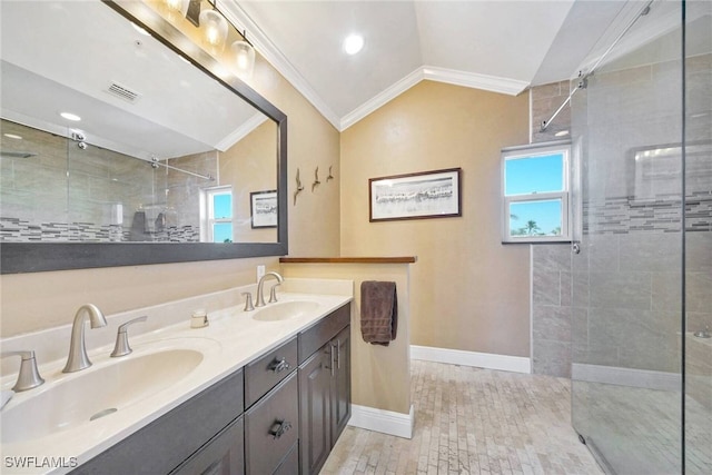 bathroom featuring lofted ceiling, vanity, a shower with door, and ornamental molding