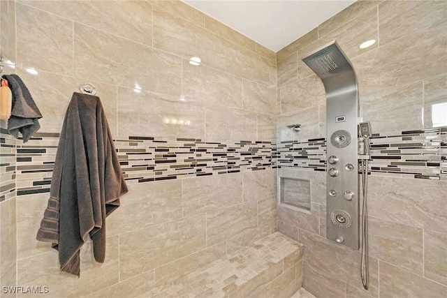 bathroom with tiled shower