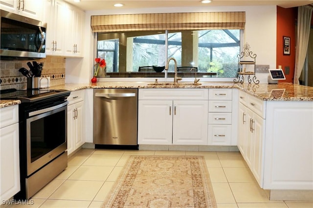 kitchen with sink, white cabinets, and appliances with stainless steel finishes