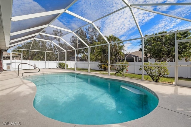 view of pool featuring a patio and glass enclosure