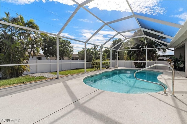 view of pool featuring a patio area and glass enclosure