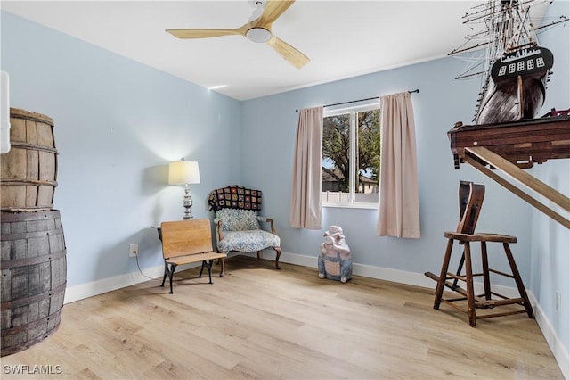 living area featuring ceiling fan and light wood-type flooring