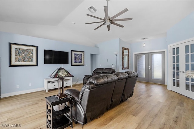 living room with french doors, ceiling fan, lofted ceiling, and light wood-type flooring