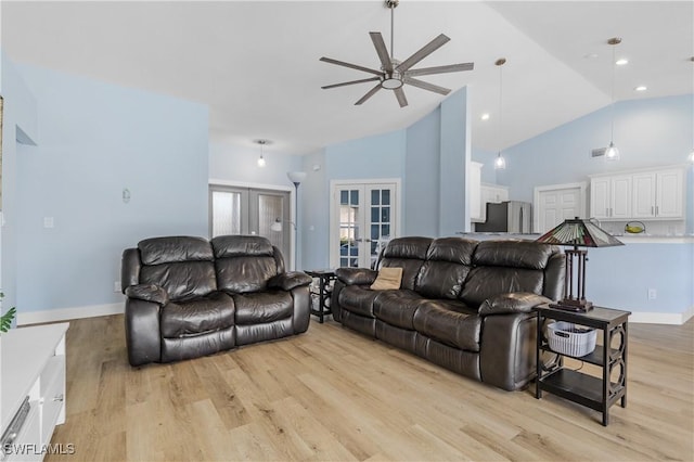 living room featuring ceiling fan, high vaulted ceiling, light hardwood / wood-style floors, and french doors