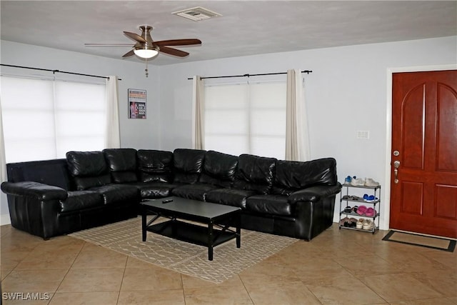 tiled living room featuring ceiling fan