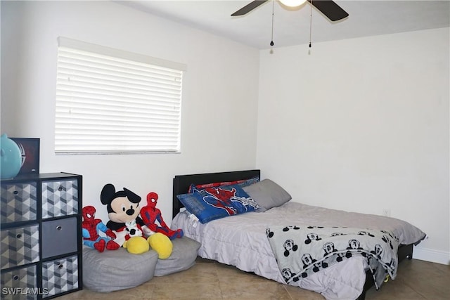 tiled bedroom featuring ceiling fan