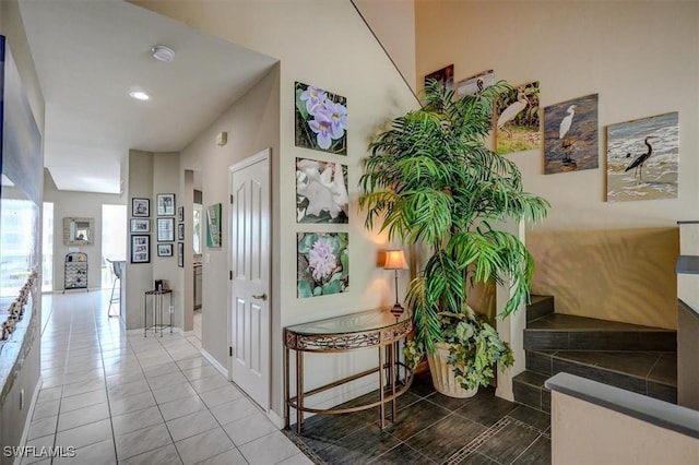 hallway with tile patterned floors