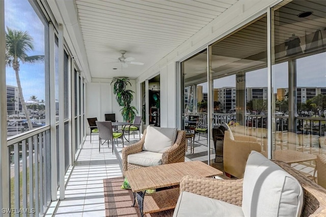 sunroom featuring a wealth of natural light and ceiling fan