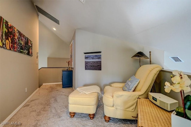 sitting room with carpet floors and lofted ceiling