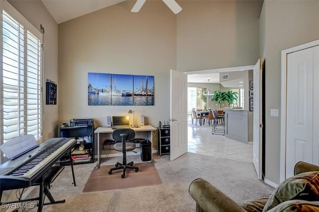 carpeted office with ceiling fan, high vaulted ceiling, and a healthy amount of sunlight