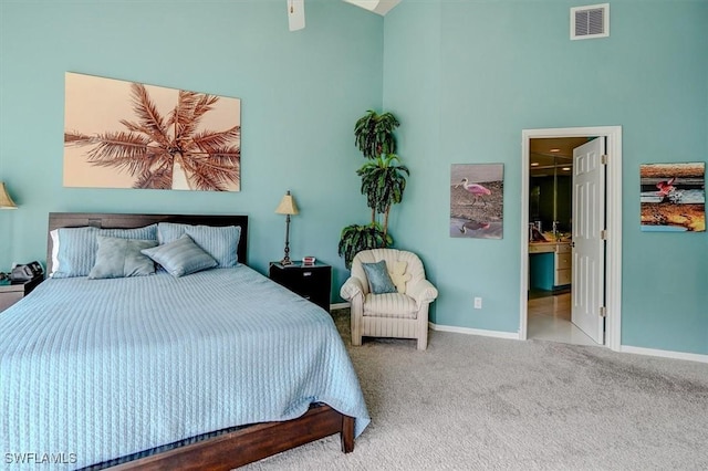 bedroom with connected bathroom and carpet