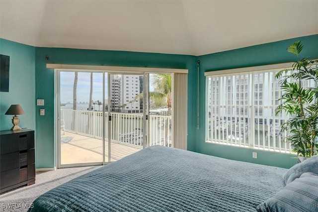 bedroom with access to outside, carpet floors, and multiple windows