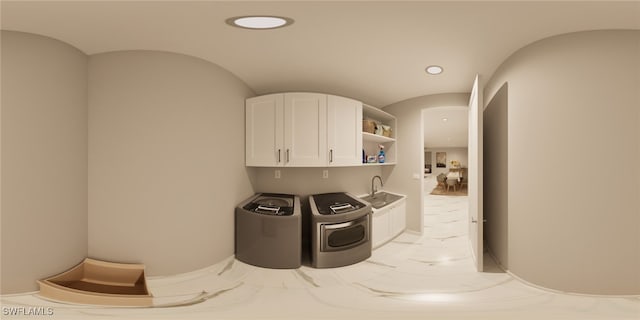 laundry area with cabinets, independent washer and dryer, and sink