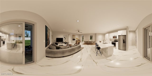 living room featuring ceiling fan and sink