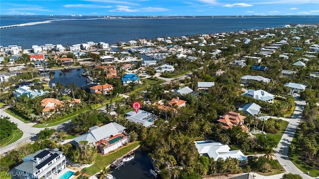 drone / aerial view featuring a water view and a residential view