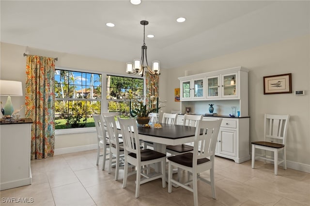 dining room featuring an inviting chandelier, light tile patterned floors, baseboards, and recessed lighting