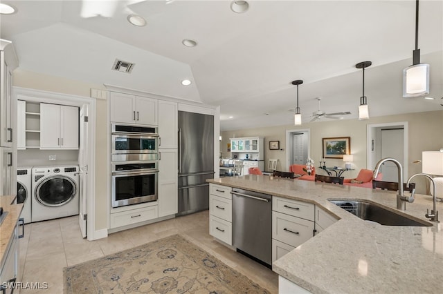 kitchen featuring a sink, visible vents, white cabinets, hanging light fixtures, and appliances with stainless steel finishes