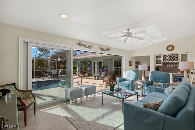 living area featuring lofted ceiling, ceiling fan, and recessed lighting