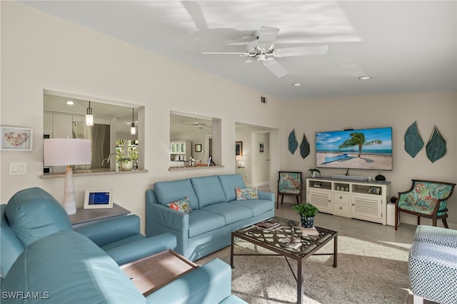 living room featuring lofted ceiling, ceiling fan, visible vents, and recessed lighting