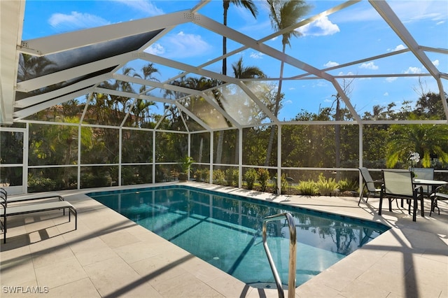 outdoor pool featuring glass enclosure and a patio area