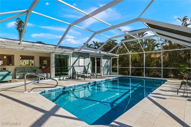 outdoor pool with a lanai, a patio, and an outdoor hangout area