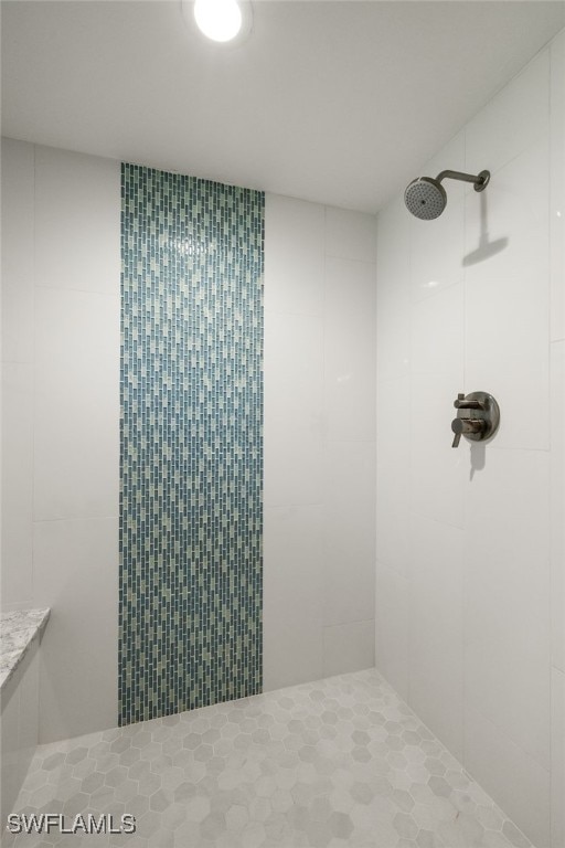 bathroom with tiled shower