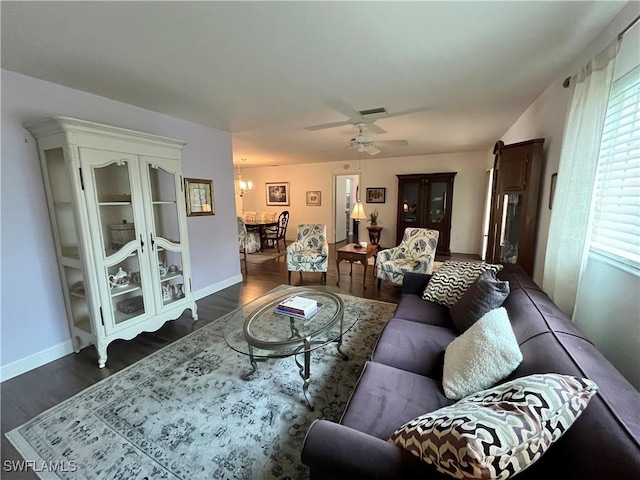 living room featuring hardwood / wood-style floors and ceiling fan with notable chandelier