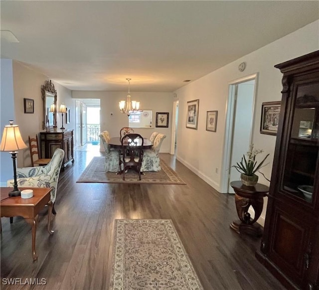 dining room featuring dark hardwood / wood-style flooring and a notable chandelier