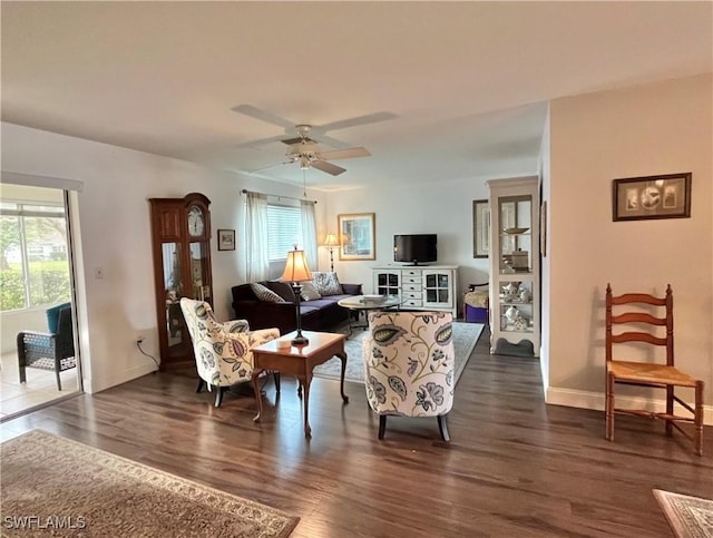 living room featuring dark hardwood / wood-style floors and ceiling fan