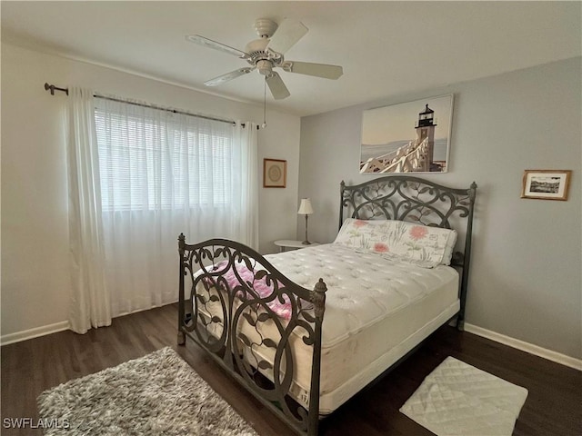 bedroom with dark wood-type flooring and ceiling fan