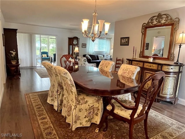 dining area featuring dark hardwood / wood-style floors and a notable chandelier