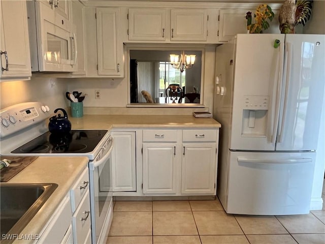 kitchen featuring light tile patterned flooring, an inviting chandelier, decorative light fixtures, white appliances, and white cabinets