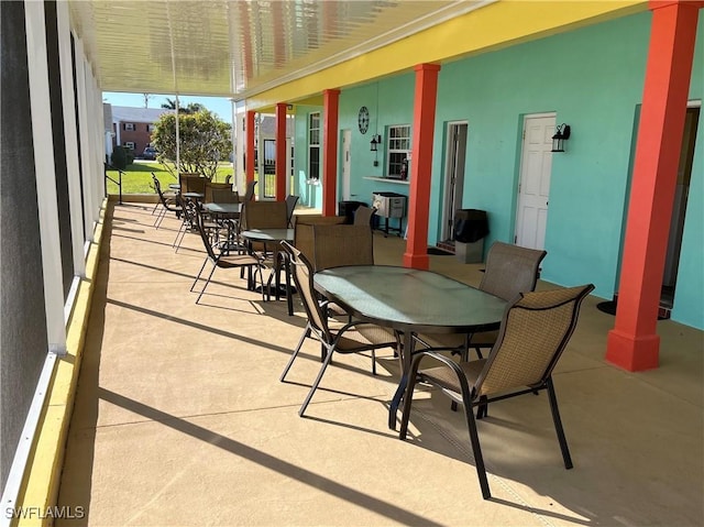 sunroom / solarium featuring decorative columns