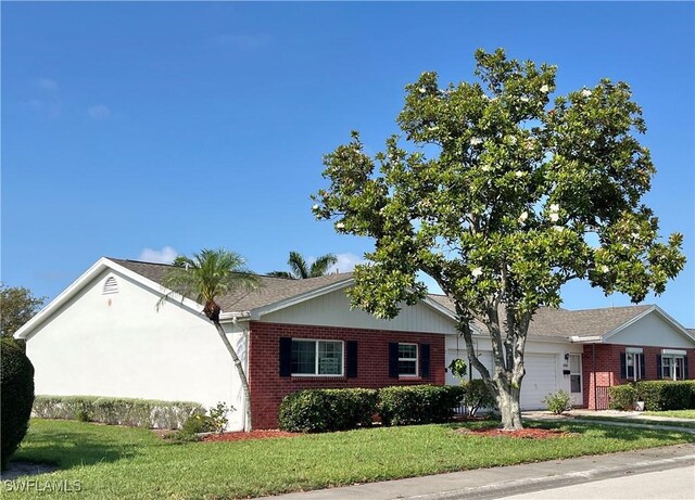 1374 Eagle Way, Fort Myers, FL 33919 - ranch-style home featuring an attached garage, brick siding, and a front yard