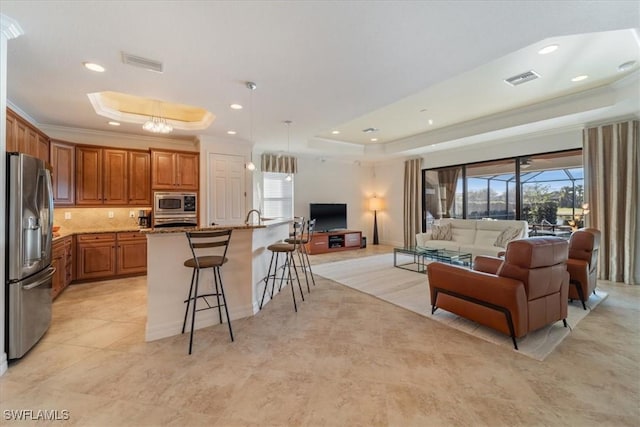 living room featuring ornamental molding and a raised ceiling