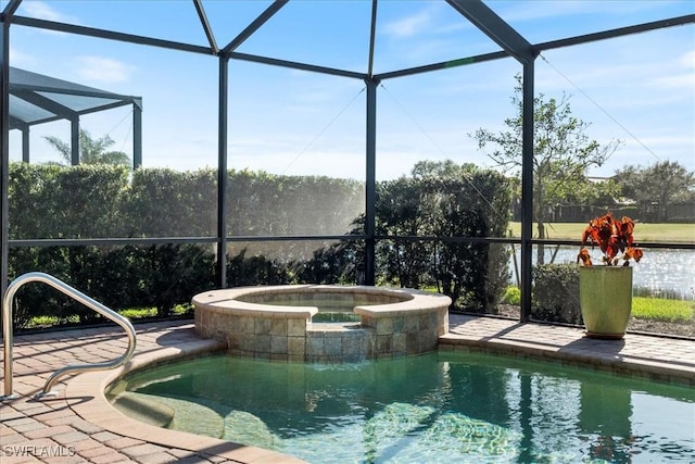 view of pool featuring a lanai, a patio, and an in ground hot tub