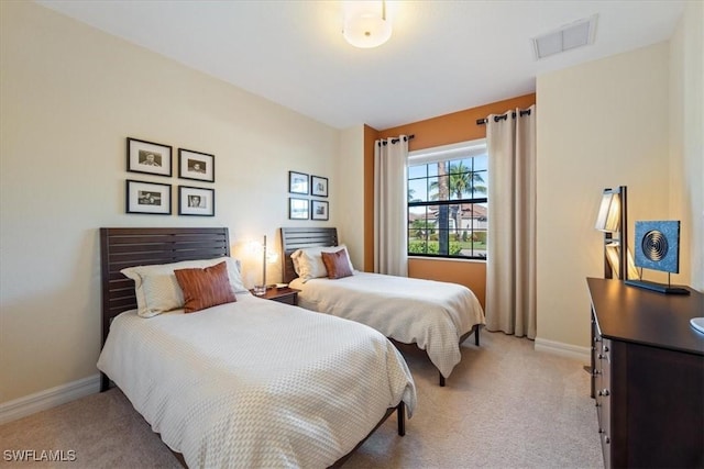 bedroom with light colored carpet