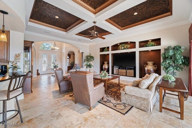 living room featuring french doors, a towering ceiling, coffered ceiling, and crown molding