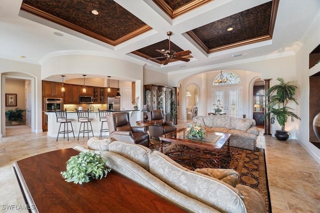 living room featuring french doors, coffered ceiling, crown molding, ceiling fan, and a high ceiling