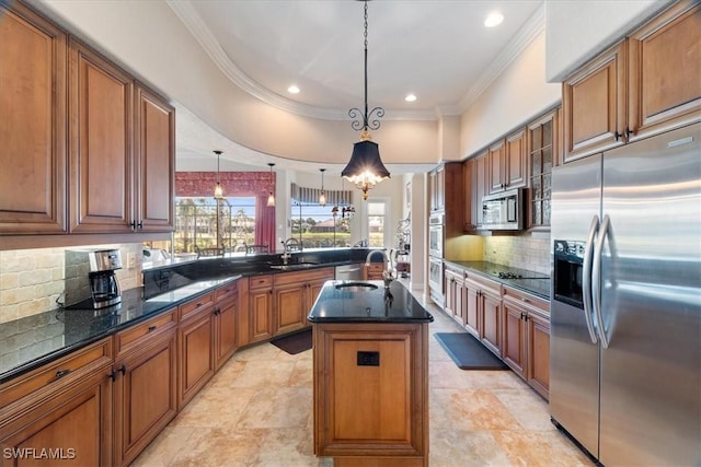 kitchen with pendant lighting, a kitchen island with sink, stainless steel appliances, tasteful backsplash, and ornamental molding