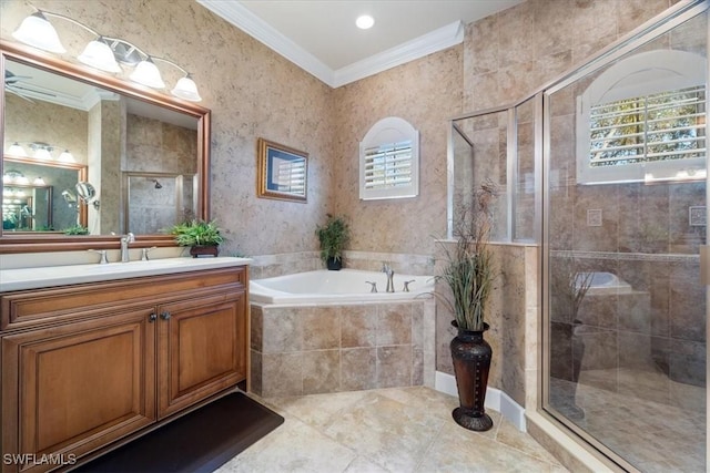 bathroom featuring independent shower and bath, ornamental molding, a wealth of natural light, and vanity