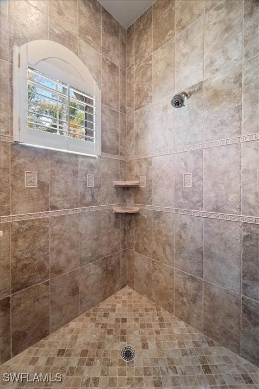 bathroom with a tile shower