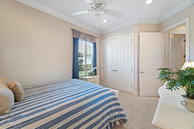 bedroom with ceiling fan, a closet, ornamental molding, and light carpet