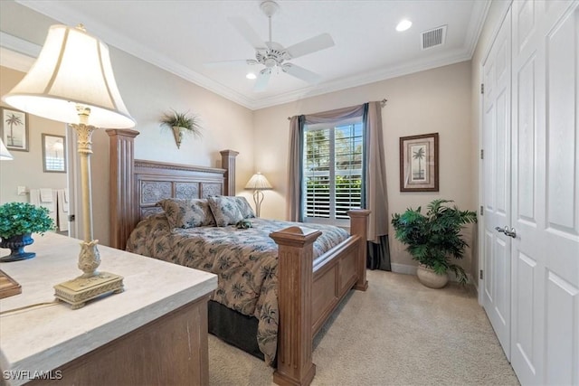 carpeted bedroom with ornamental molding, ceiling fan, and a closet