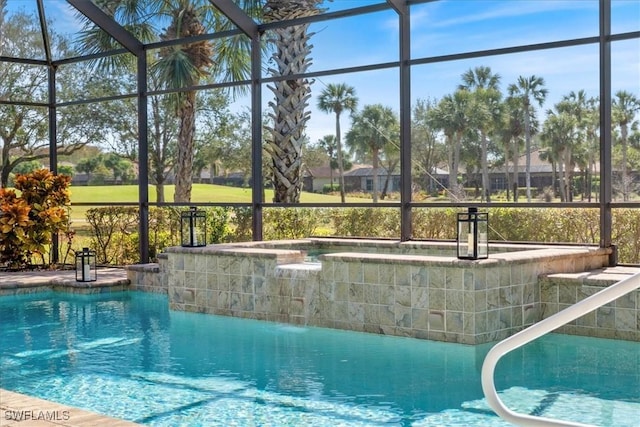 view of swimming pool featuring a lanai and a hot tub