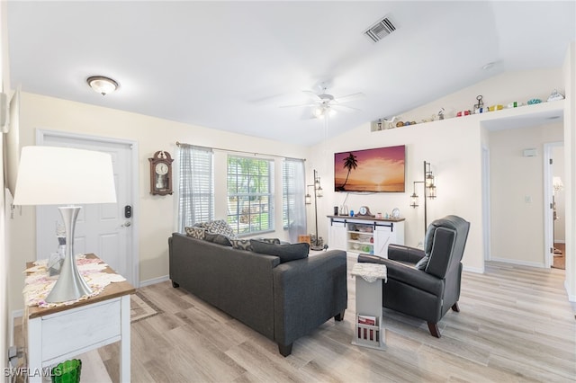 living room featuring ceiling fan, lofted ceiling, and light hardwood / wood-style floors