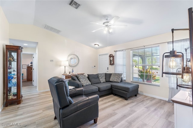 living room featuring ceiling fan, light hardwood / wood-style floors, and vaulted ceiling