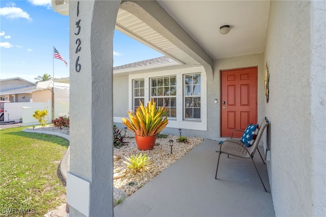 doorway to property with a yard