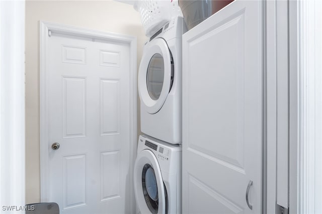 clothes washing area with stacked washer and dryer